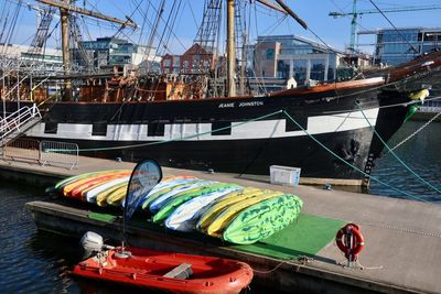 Sailboats moored at harbor