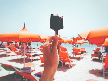 Close-up of people on beach against clear sky