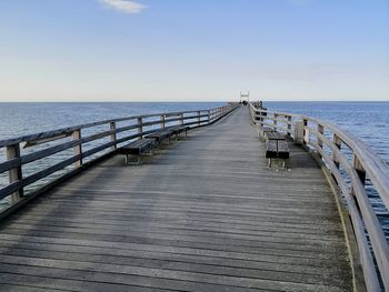 Pier over sea against sky