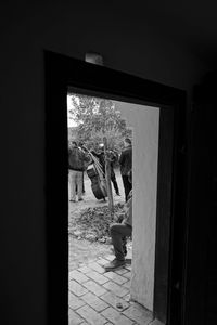 Man looking through window