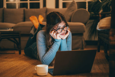 Portrait of woman using digital tablet while sitting in cafe