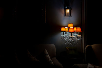 Illuminated electric lamp on sofa at home