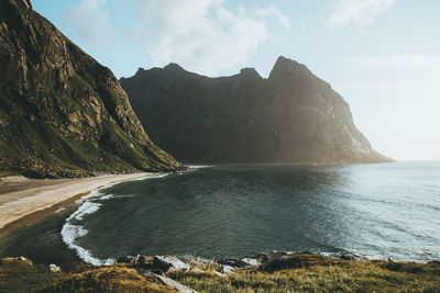 Scenic view of sea and mountains against sky