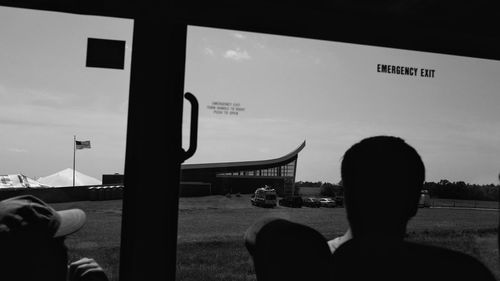 Man at airport against sky