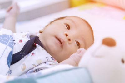 Cute baby lying on bed