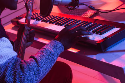 High angle view of person playing piano