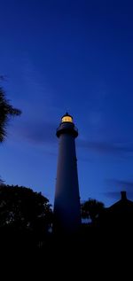 Low angle view of lighthouse against sky at dusk