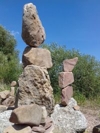 Stack of stones against clear blue sky