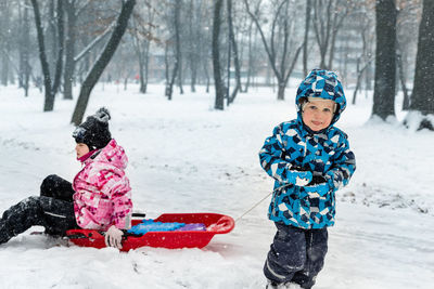 Rear view of people in snow