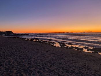 Scenic view of beach against sky during sunset