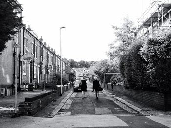 People walking on footpath in city