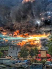 Cars parked on road at sunset