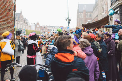 People on street in city against clear sky