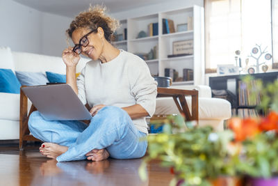 Young woman using laptop at home