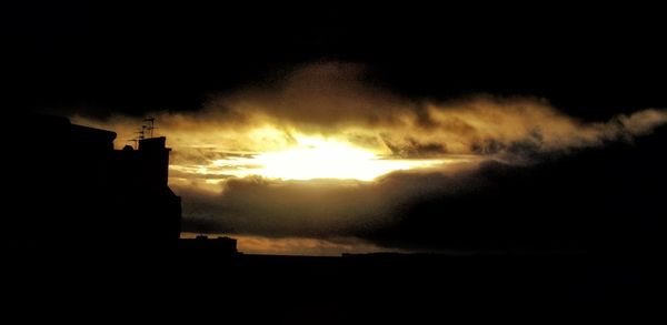 Silhouette of building at sunset