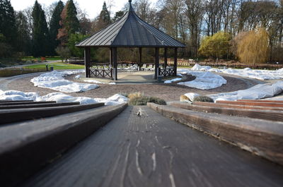 Gazebo by trees against sky