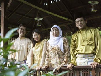 Low angle portrait of family standing in gazebo at yard