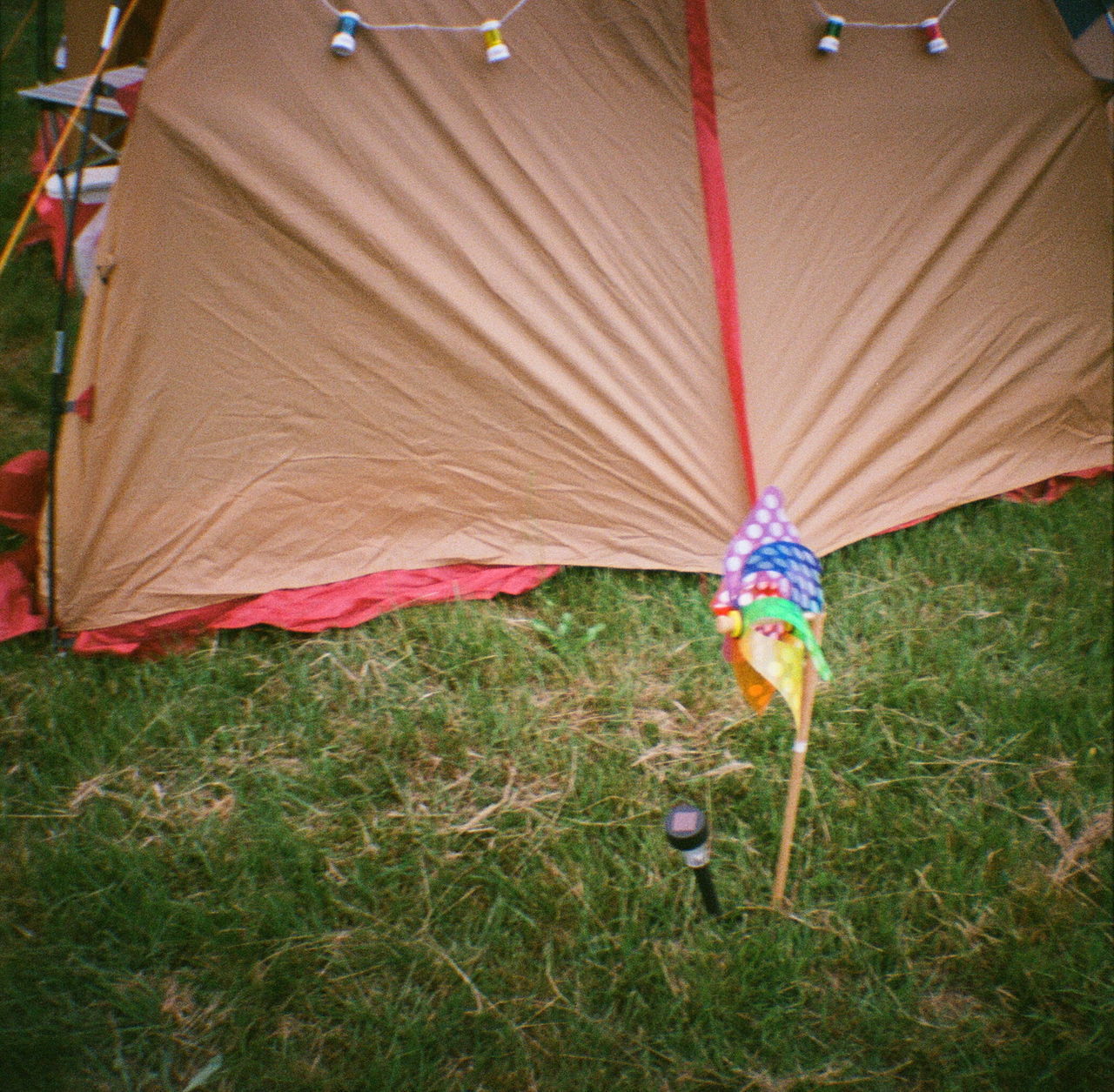 LOW SECTION OF MAN WITH UMBRELLA ON TENT