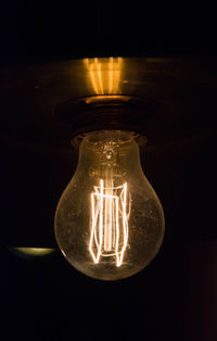 Close-up of lit candle in dark room