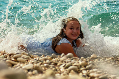 Little girl playing with the wave