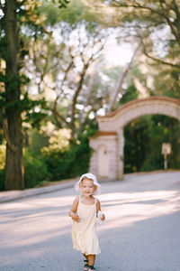 Young woman standing on road