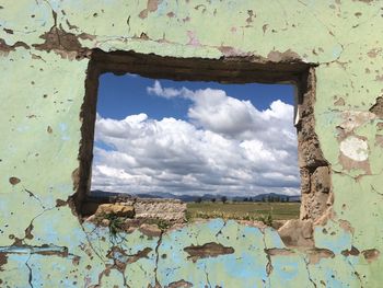 Abandoned building against cloudy sky