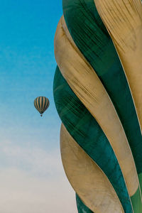 Low angle view of hot air balloon against blue sky