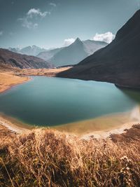 Scenic view of lake and mountains against sky
