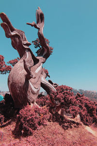 Low angle view of sculpture against clear blue sky