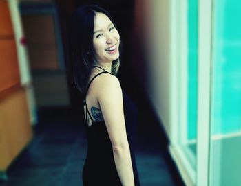 Portrait of smiling young woman standing outdoors