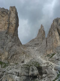 Low angle view of rocky mountains against sky