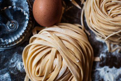 Overhead view of pasta with flour on table