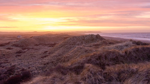 Scenic view of landscape against sky during sunset