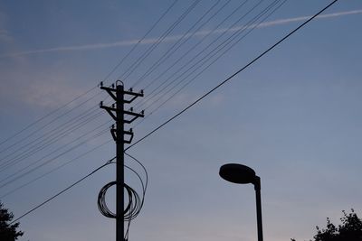 Low angle view of electricity pylon against sky