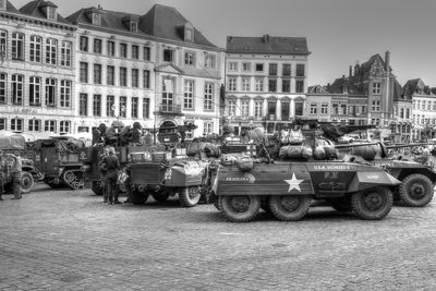 Vehicles on road against buildings in city