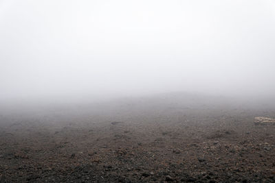 Scenic view of landscape against sky during foggy weather