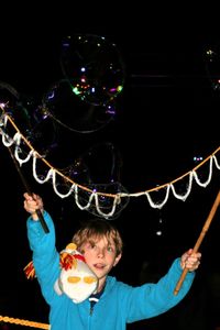 Boy with multi colored lights against black background