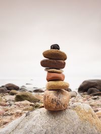 Stones pyramid symbolizing zen, harmony, balance. colorful stones for meditation lying on beach