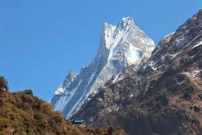 Scenic view of mountains against clear blue sky