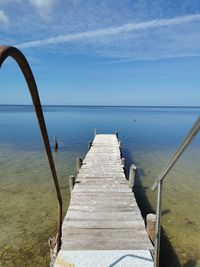 Pier over sea against sky