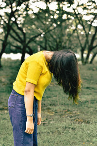 Side view of woman standing outdoors