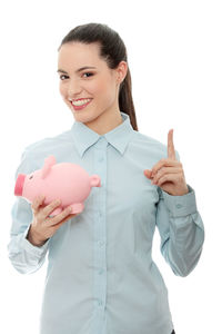 Portrait of a smiling young woman over white background
