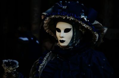 Person wearing venetian mask at carnival