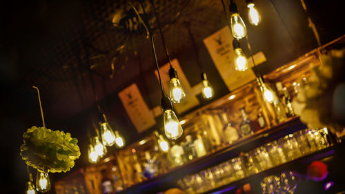 Low angle view of illuminated lanterns hanging at night