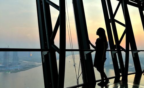 Silhouette boy standing against sky