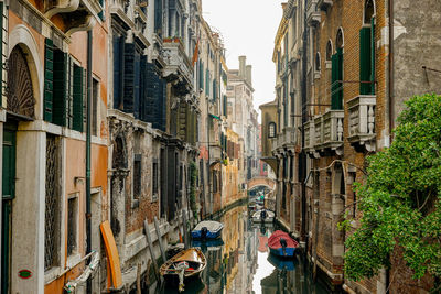 People walking on street amidst buildings in city