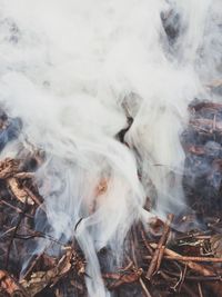 High angle view of smoke emitting from land