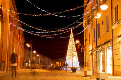Illuminated christmas lights on building at night
