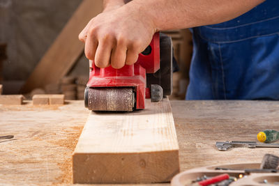 Midsection of man working at workshop