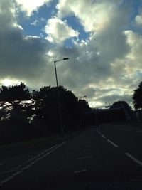 Empty road against cloudy sky